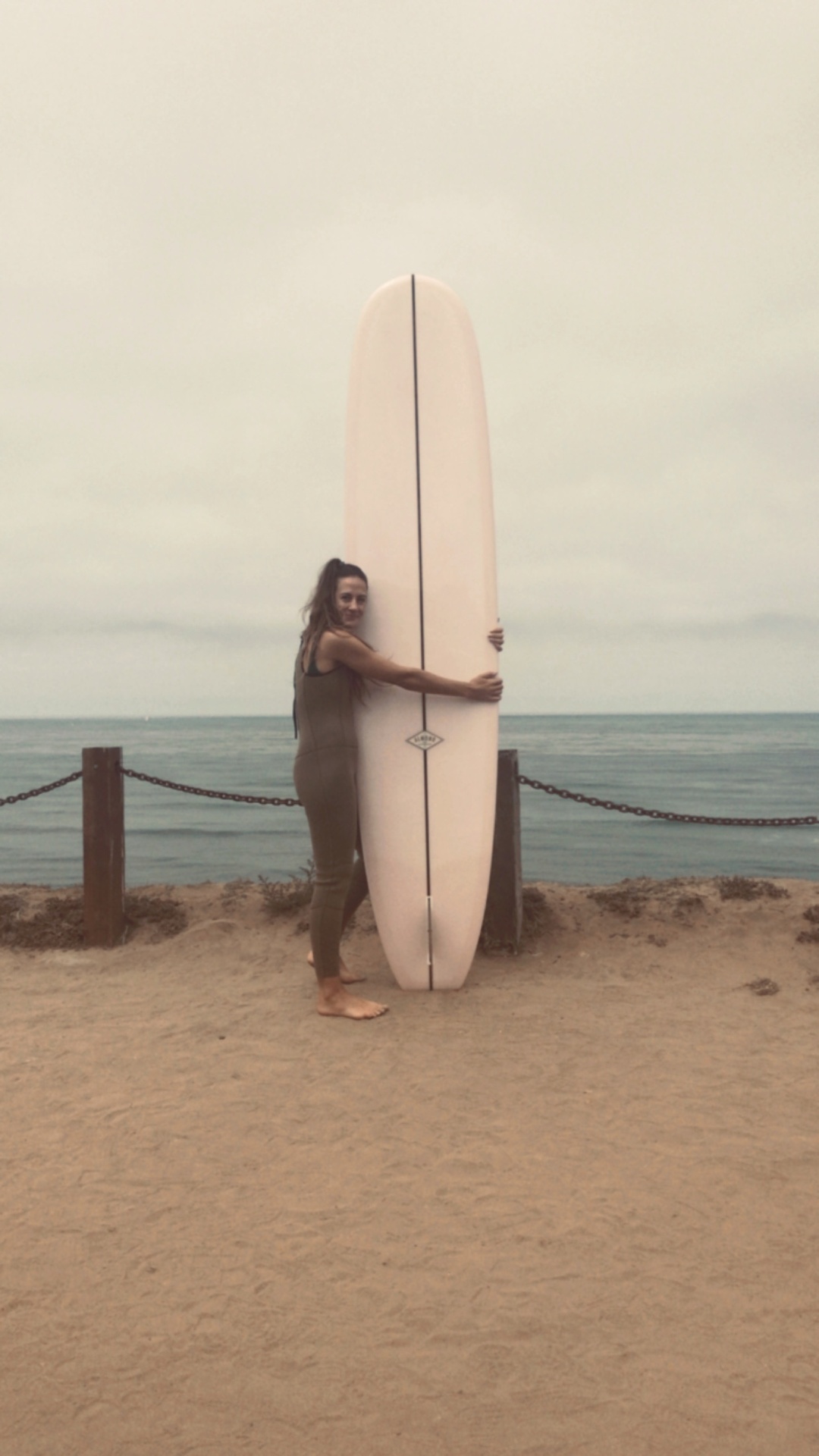 Charlotte Holt with a surfboard