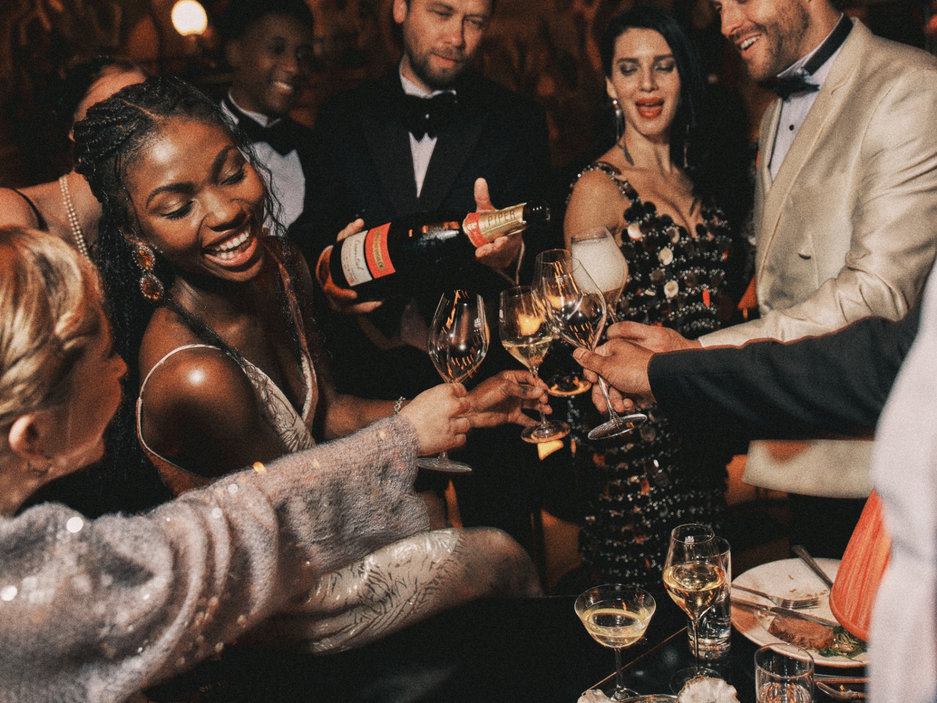 Guests toasting champagne at The Lost Estate cabaret dinner by Charlie McKay